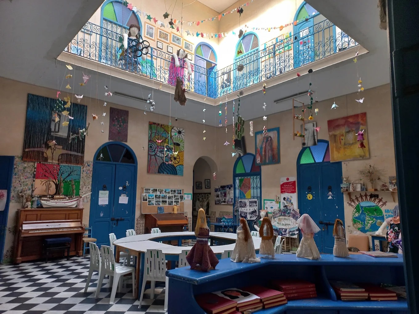 Community Impact 6 Association Darna, Tangier: colourful courtyard with handmade dolls and artwork
