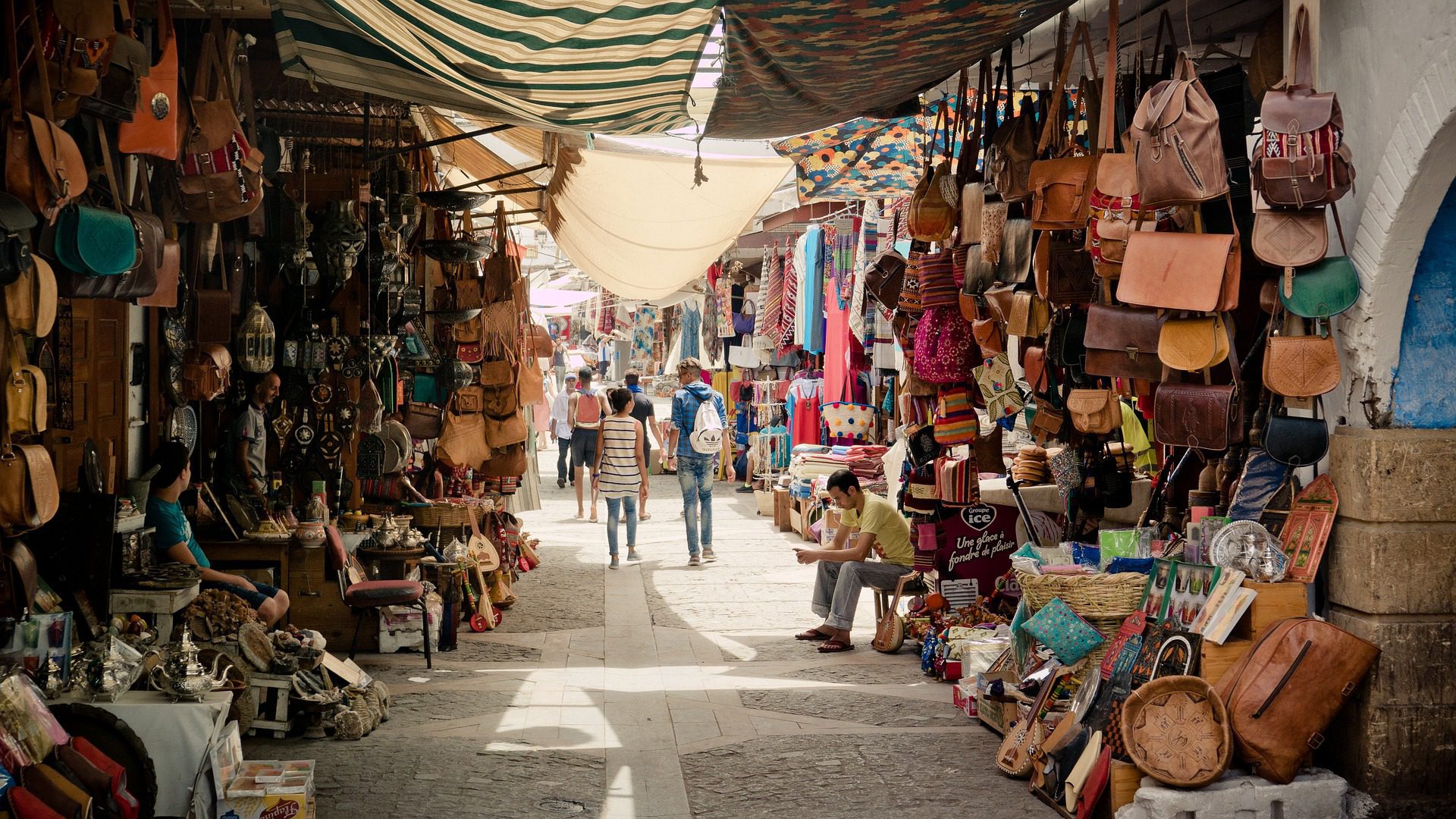 A shaded souk street lined with leather goods